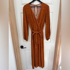 Billabong long-sleeved jumpsuit in a rust color with a red &black floral pattern